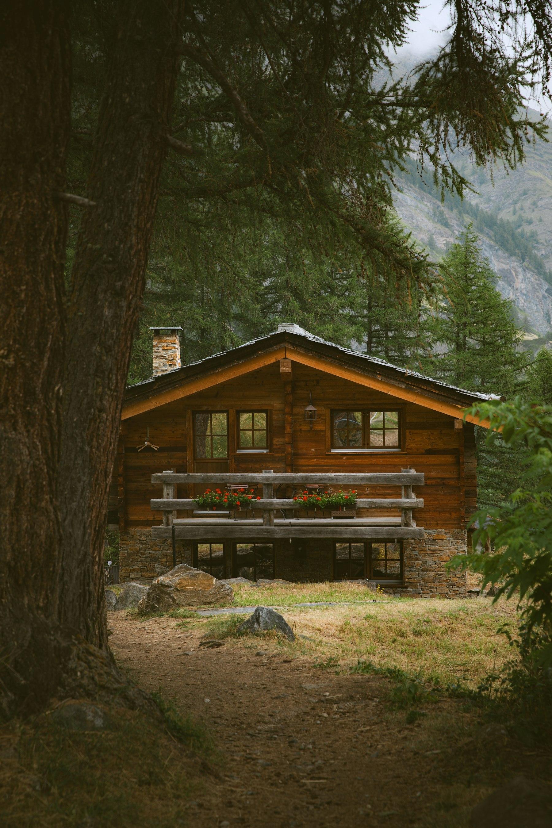A wooden cabin nestled in the woods near Zermatt, Switzerland. Photo by Ryan Klaus on Unsplash.